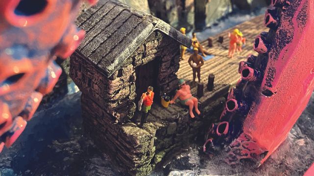 Miniaturlandschaft mit Riesententakeln nebst Miniaturmenschen.