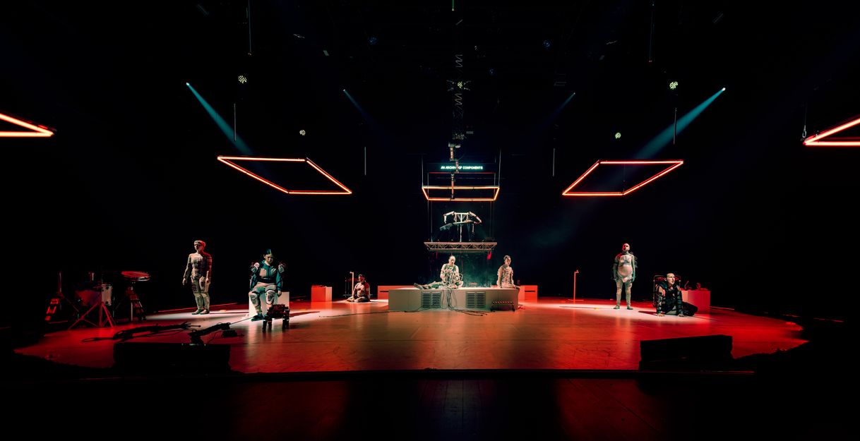 Part of the performance Eternal Dawn, showing performers in robot-like costumes on stage.