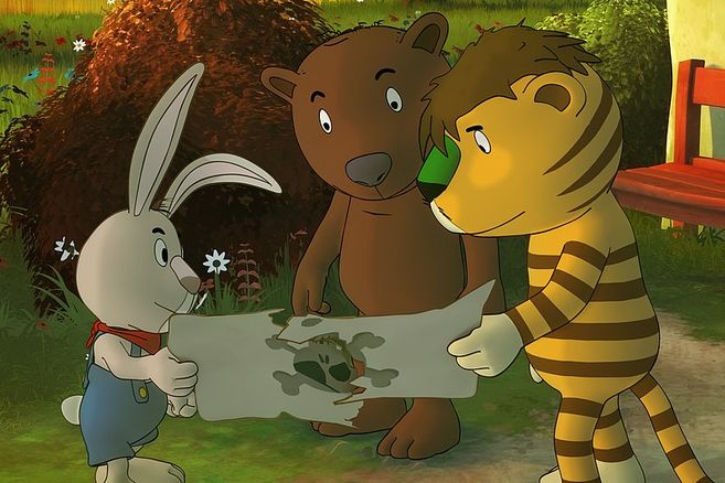 Ein Hase, ein Bär und Tiger schauen gemeinsam auf eine Schatzkarte