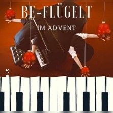 Ein Klavier mit Weihnachtskugeln und der Schriftzug 'Be-Flügelt im Advent'.