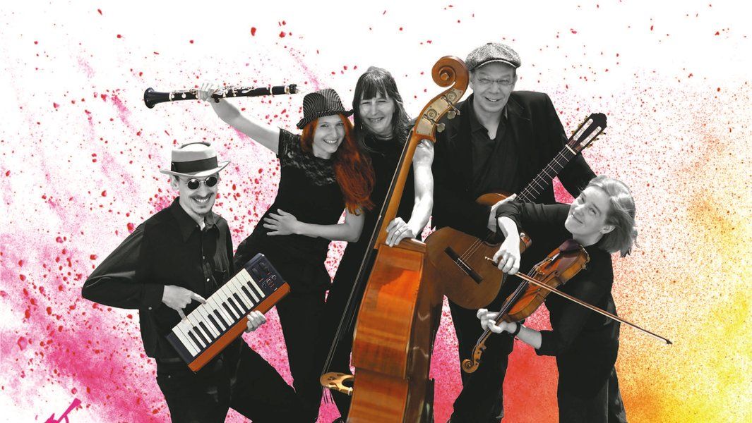 Eine fröhliche Musikgruppe mit verschiedenen Instrumenten vor einem bunten Hintergrund.