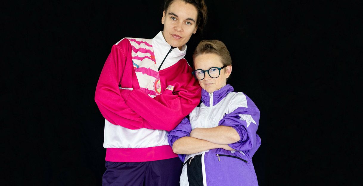 Two people hug each other.