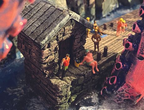 Miniaturlandschaft mit Riesententakeln nebst Miniaturmenschen.