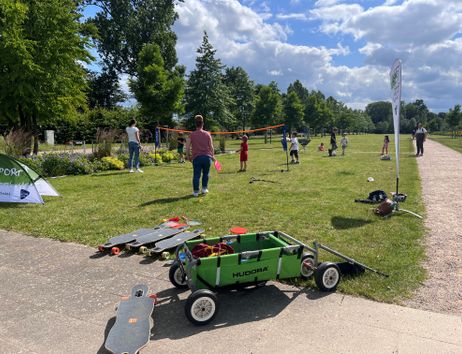 Kinder und Erwachsene machen auf einer Wiese Sport