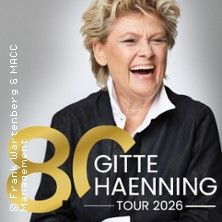Eine lächelnde Frau mit kurzem blondem Haar in einem schwarzen Outfit. Text: "80 Gitte Haenning Tour 2026".