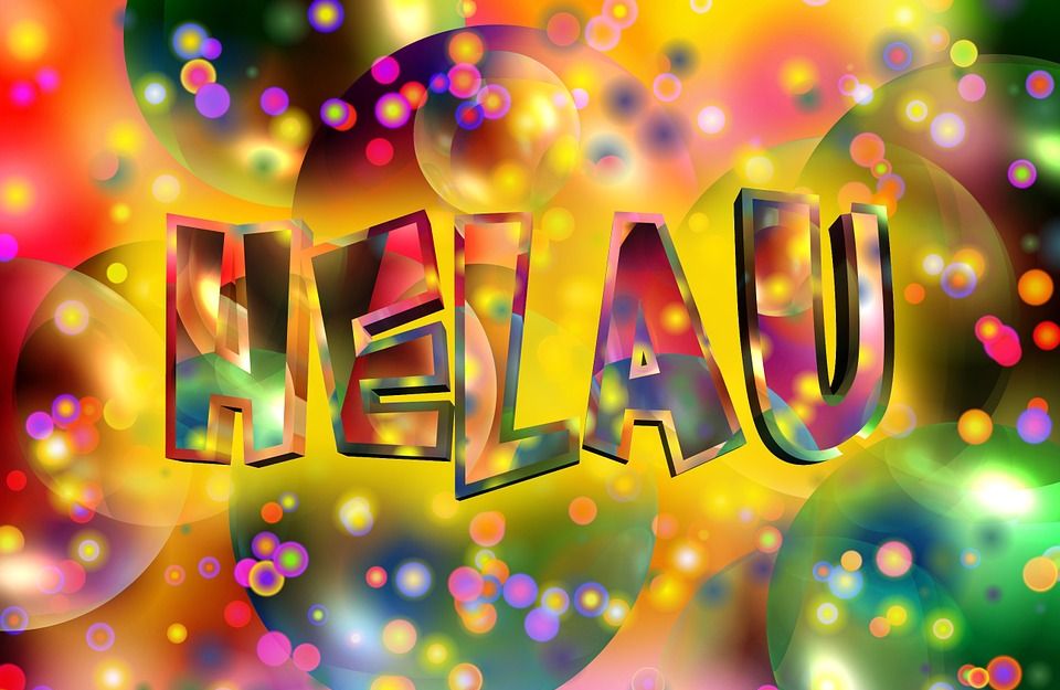 Bunte Grafik mit dem Wort 'Helau' in großen Buchstaben, umgeben von farbenfrohen Kreisen und Punkten.