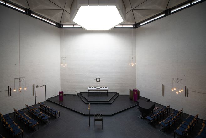 Innenansicht der Ansgarkirche mit Altar und Sitzreihen.