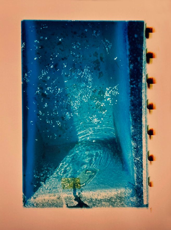 Das Bild hat einen cremefarbenen Hintergrund. In die Mitte ist ein Bild gedruckt, das aussieht, als würde man in einen Pool blicken.