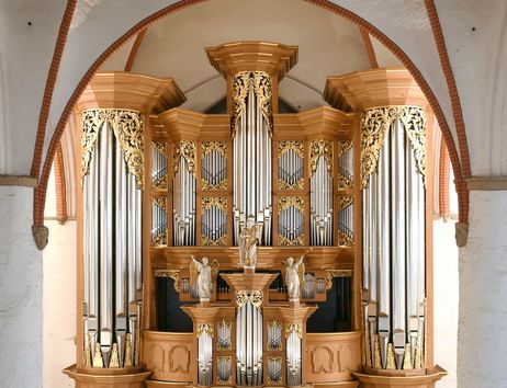 Eine prächtige Orgel mit goldenen Verzierungen und Pfeifen in einer Kirche.