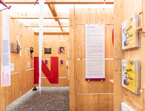 Ein Ausstellungsaufbau mit hölzernen Wänden.