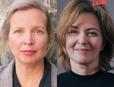 Zwei Frauen nebeneinander, eine mit blonden Haaren und eine mit braunen Haaren, vor neutralem Hintergrund.
