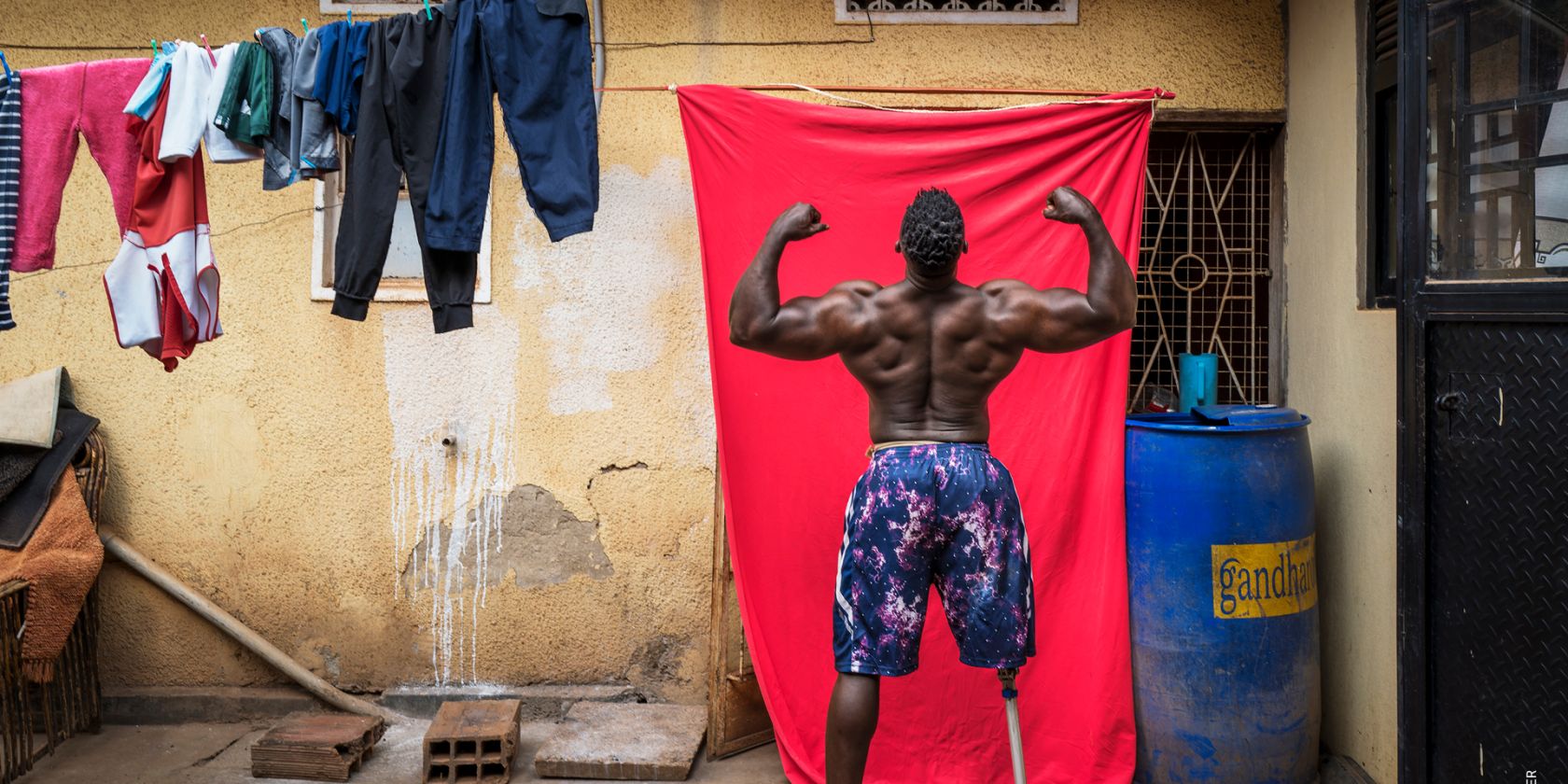 Africa Singles, Marijn Fidder, Bodybuilder Tamale Safalu trains in front of his home, Uganda, 2024, © Marijn Fidder